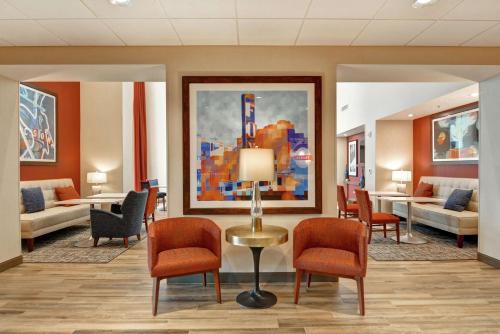 a lobby with a waiting room with chairs and a table at Hampton Inn & Suites Tucson Marana in Marana