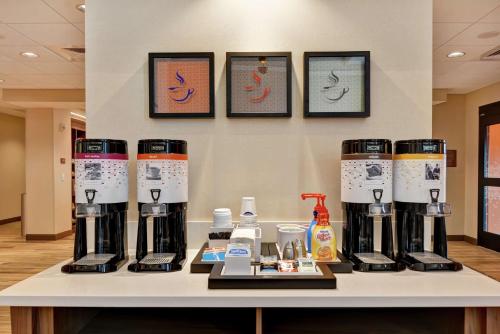 a group of four coffee machines on a counter at Hampton Inn & Suites Tucson Marana in Marana