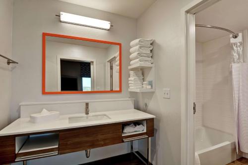 a bathroom with a sink and a mirror and a shower at Hampton Inn & Suites Tucson Marana in Marana