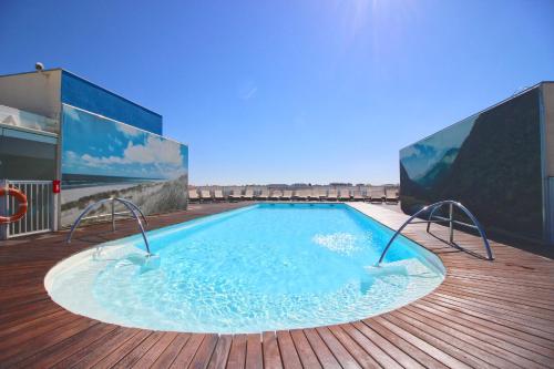 a swimming pool on the roof of a building at Radisson Blu Hotel Biarritz in Biarritz