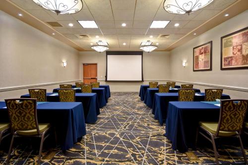 a conference room with blue tables and chairs and a whiteboard at Hilton Garden Inn Twin Falls in Twin Falls