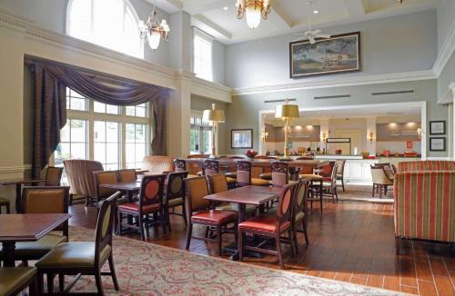 a restaurant with tables and chairs and a bar at Hampton Inn & Suites - Vicksburg in Vicksburg