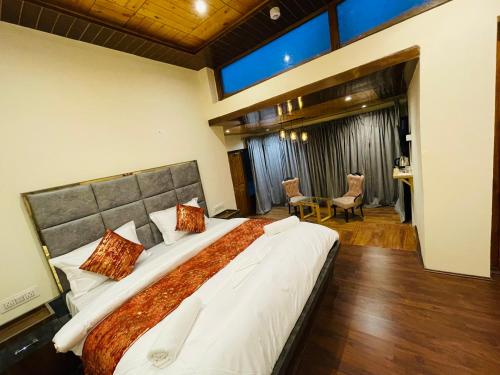 a bedroom with a large bed in a room at Thiksay Organic Resort in Ranbirpura