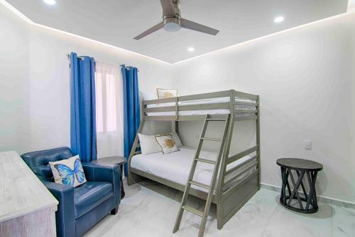a bedroom with a bunk bed and a chair at Casa Blanca Golf Villas in Puerto Peñasco