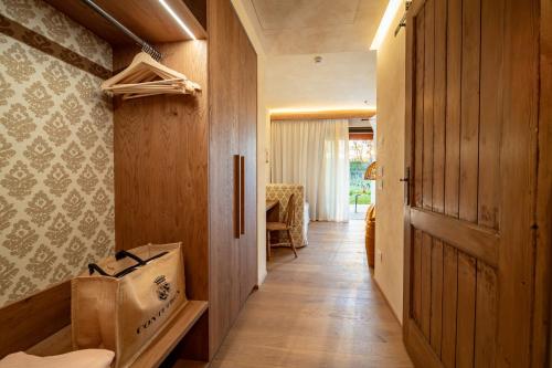 a hallway of a house with a door and a chair at Conti Thun Wine Resort in Puegnano del Garda
