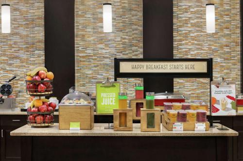 a counter with apples and other food items on it at Hampton Inn Washington-Dulles International Airport South in Chantilly