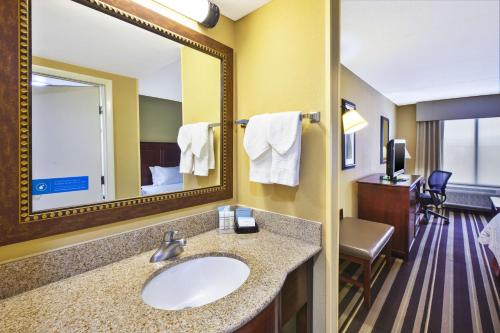 a bathroom with a sink and a mirror at Hampton Inn Washington-Dulles International Airport South in Chantilly