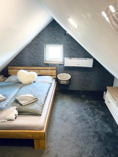 a attic bedroom with two beds and a sink at Maul - Lator Présbár és Bortrezor in Villány