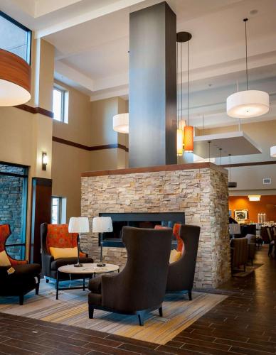 a lobby of a hotel with a fireplace and chairs at Hampton Inn & Suites Boulder North in Boulder