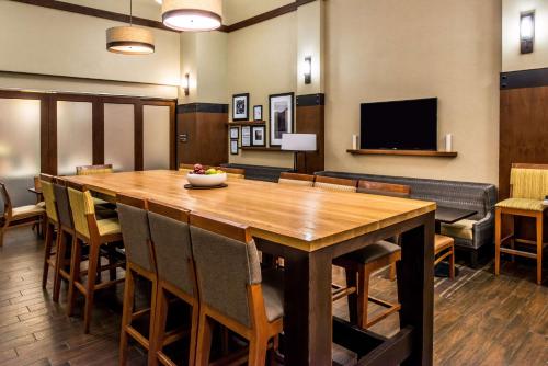 a dining room with a large wooden table and chairs at Hampton Inn & Suites Boulder North in Boulder