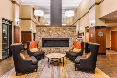 a waiting room with chairs and a fireplace at Hampton Inn & Suites Boulder North in Boulder