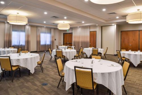 a conference room with white tables and chairs at Hampton Inn & Suites Boulder North in Boulder