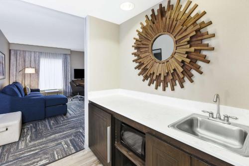 a kitchen and a living room with a sink and a mirror at Hampton Inn & Suites Wells-Ogunquit in Wells