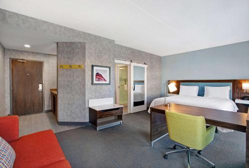 a hotel room with a bed and a desk at Hampton Inn & Suites By Hilton Waterloo St. Jacobs in Waterloo