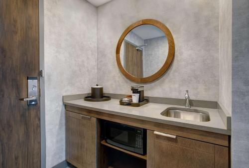 a bathroom with a sink and a mirror at Hampton Inn & Suites By Hilton Waterloo St. Jacobs in Waterloo