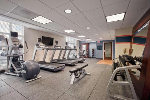 a gym with several treadmills and machines in a room at Hampton Inn & Suites Providence-Warwick Airport in Warwick