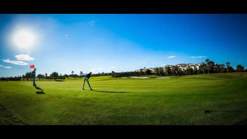 Facet stoi na polu golfowym. w obiekcie Roda Golf Sunparadise w mieście San Javier