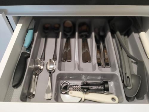 a drawer filled with utensils in a drawer at Zmaj 94 in Bečej