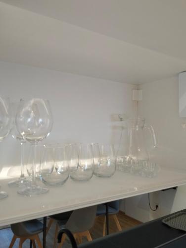 a row of wine glasses sitting on a table at Zmaj 94 in Bečej