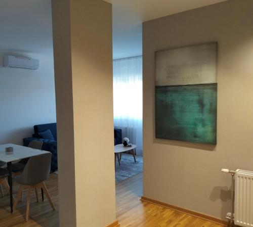 a view of a living room with a painting on the wall at Zmaj 94 in Bečej