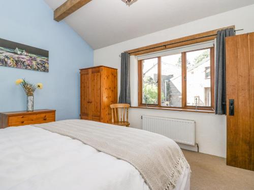 a bedroom with a large bed and a window at Egg Pudding Stone in Grange Over Sands