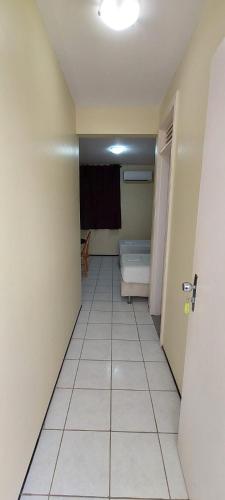 a room with a hallway with a room with a bed at Hotel Praia 2000 in Fortaleza