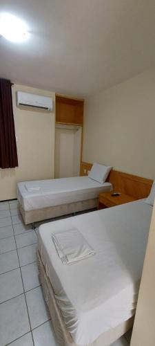 a room with two beds in a room at Hotel Praia 2000 in Fortaleza