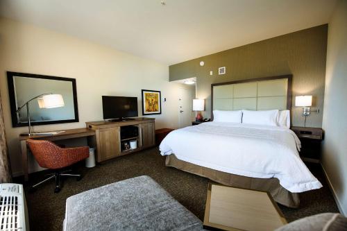 a hotel room with a large bed and a television at Hampton Inn & Suites Truro, NS in Truro