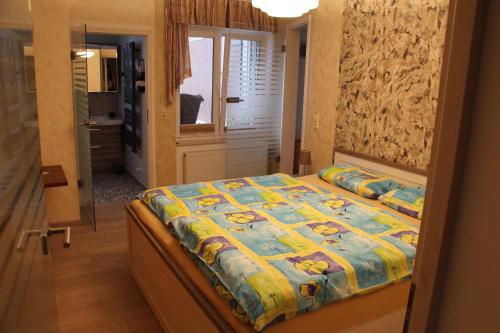 a bedroom with a bed with a quilt on it at Zur Alten Schmiede mit Museum in Rüstungen