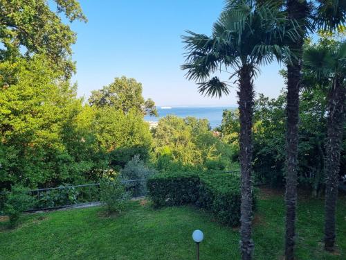 a view of the ocean from a garden at Apartmani ViVa in Lovran