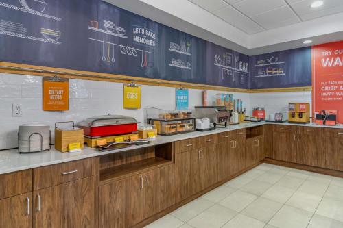 a kitchen with wooden cabinets and a counter top at Hampton Inn & Suites Edmonton/West in Edmonton