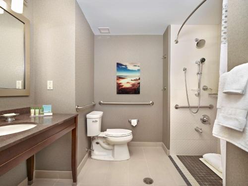 a bathroom with a toilet and a sink and a shower at Hampton Inn by Hilton Halifax Downtown in Halifax