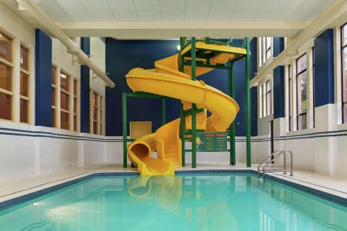 a swimming pool with a slide in a building at Hampton Inn & Suites by Hilton Langley-Surrey in Surrey