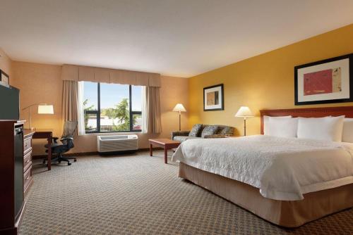 a hotel room with a bed and a desk at Hampton Inn & Suites by Hilton Langley-Surrey in Surrey