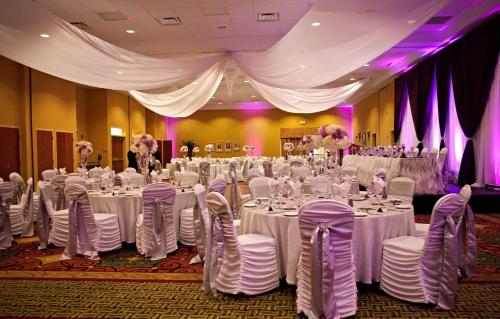 a banquet hall with white tables and chairs at Hilton Garden Inn Ottawa Airport in Ottawa