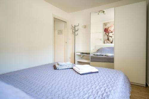 a bedroom with a bed with two towels on it at Apartman Stela u Kamporu in Kampor