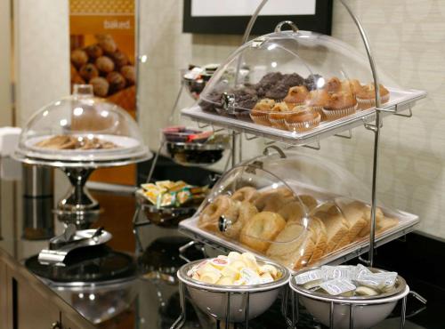 a display of different types of pastries on a counter at Hampton Inn & Suites Red Deer in Red Deer