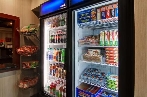 a refrigerator filled with lots of food and drinks at Hampton Inn & Suites Red Deer in Red Deer