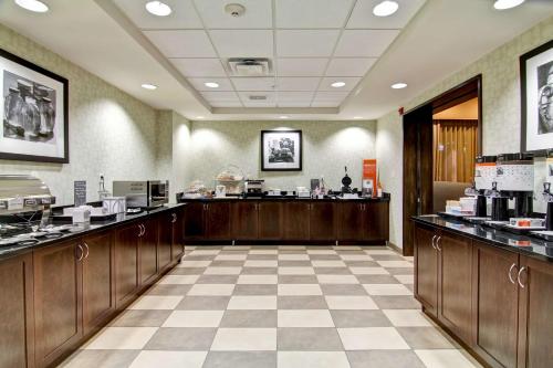 a large room with a coffee shop with a counter at Hampton Inn & Suites Red Deer in Red Deer