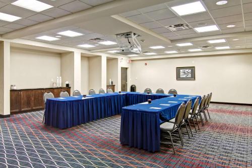 a conference room with blue tables and chairs at Hampton Inn & Suites Red Deer in Red Deer