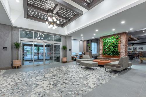 a lobby with couches and chairs in a building at Hampton Inn & Suites Charlottetown in Charlottetown