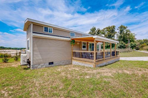 a small house with a porch on a yard at Tiny Charmer in Hendersonville