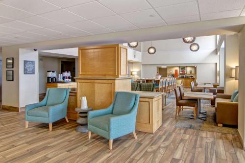 a waiting room at a hospital with chairs and tables at Hampton Inn & Suites Saint John in Saint John