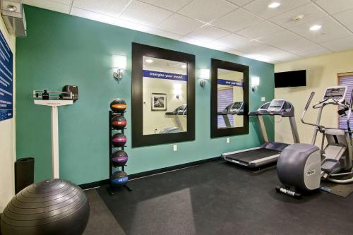 a gym with tread machines and mirrors in a room at Hampton Inn & Suites Saint John in Saint John