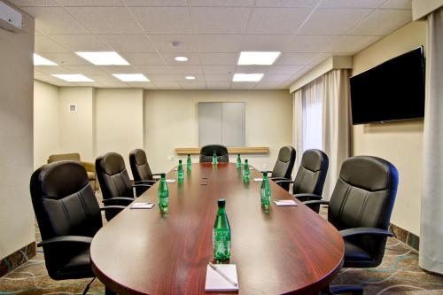 a conference room with a long wooden table and chairs at Hampton Inn & Suites Saint John in Saint John