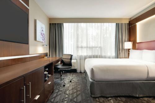 a hotel room with a bed and a desk at DoubleTree by Hilton Hotel Toronto Airport West in Mississauga