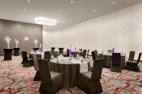 a conference room with tables and chairs and a wall at DoubleTree by Hilton Hotel Toronto Airport West in Mississauga