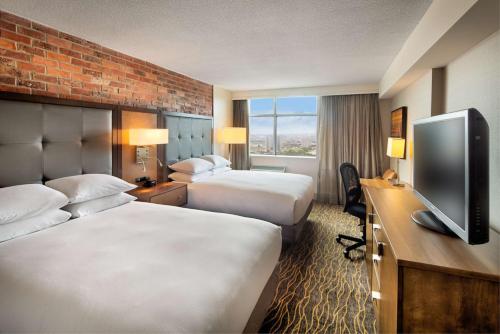 a hotel room with two beds and a flat screen tv at Doubletree by Hilton Toronto Airport, ON in Toronto