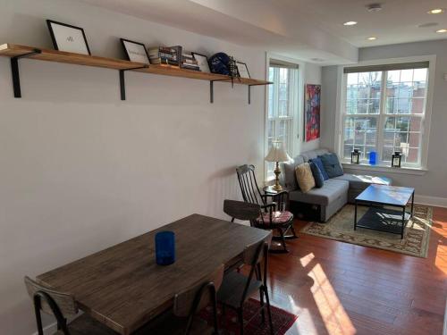 a living room with a table and a couch at Sun-filled Capitol Hill home w/ parking & roofdeck in Washington, D.C.