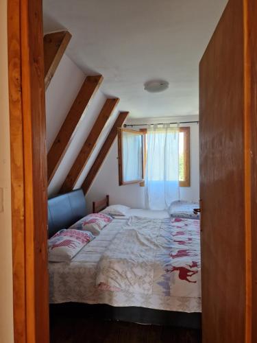 a bedroom with a bed and a window at Green Eye in Žabljak